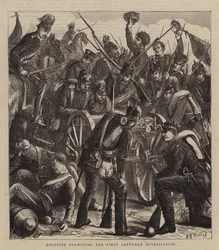 Soldaten untersuchen die erste erbeutete Mitrailleuse